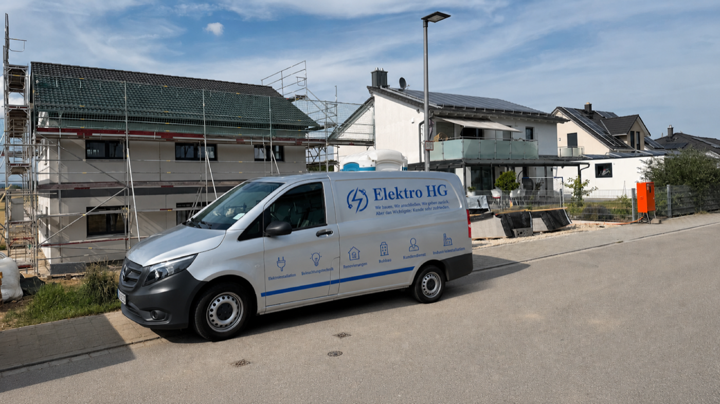 Firmenwagen von Elektro HG mit der echten Fahrzeugbeschriftung vor einer Baustelle in Ingolstadt